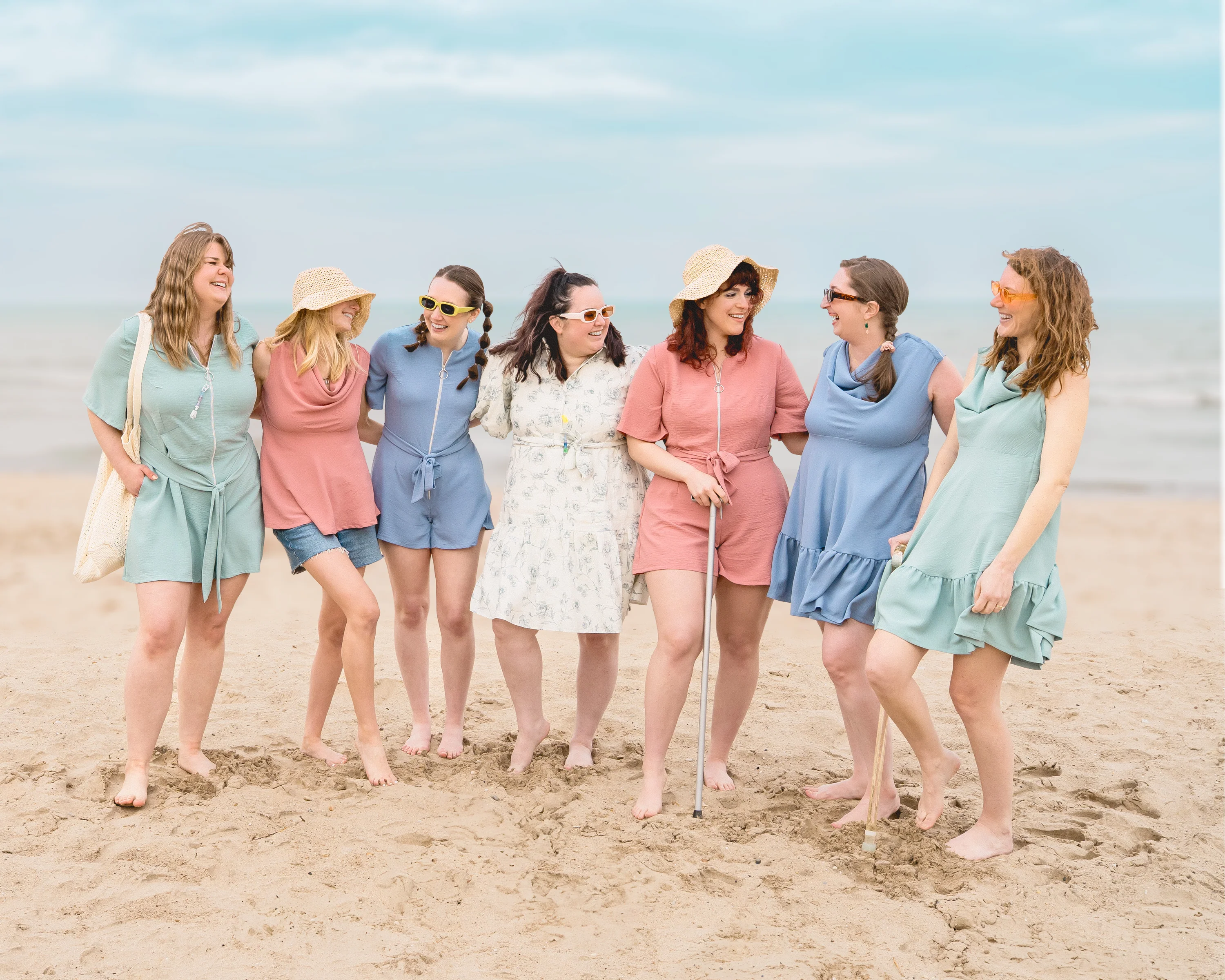 Group of women on the beach are all wearing Vertige Adaptive clothing